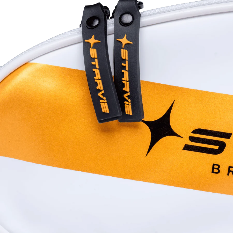 Close-up of zipper pulls and branded detail on white StarVie Skyline accessory bag
