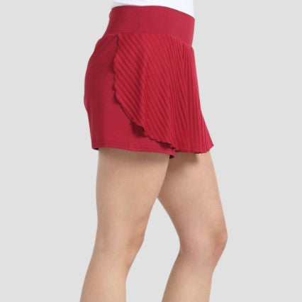 Side profile view showing pleated overlap detail on red Bullpadel Exito skort