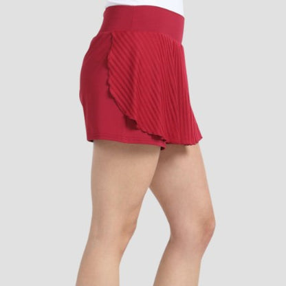 Side profile view showing pleated overlap detail on red Bullpadel Exito skort