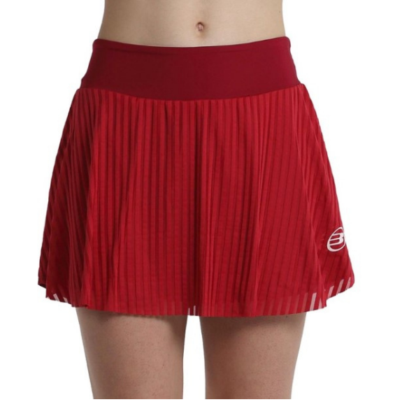 Front view of female model wearing red pleated Bullpadel Exito women's skort