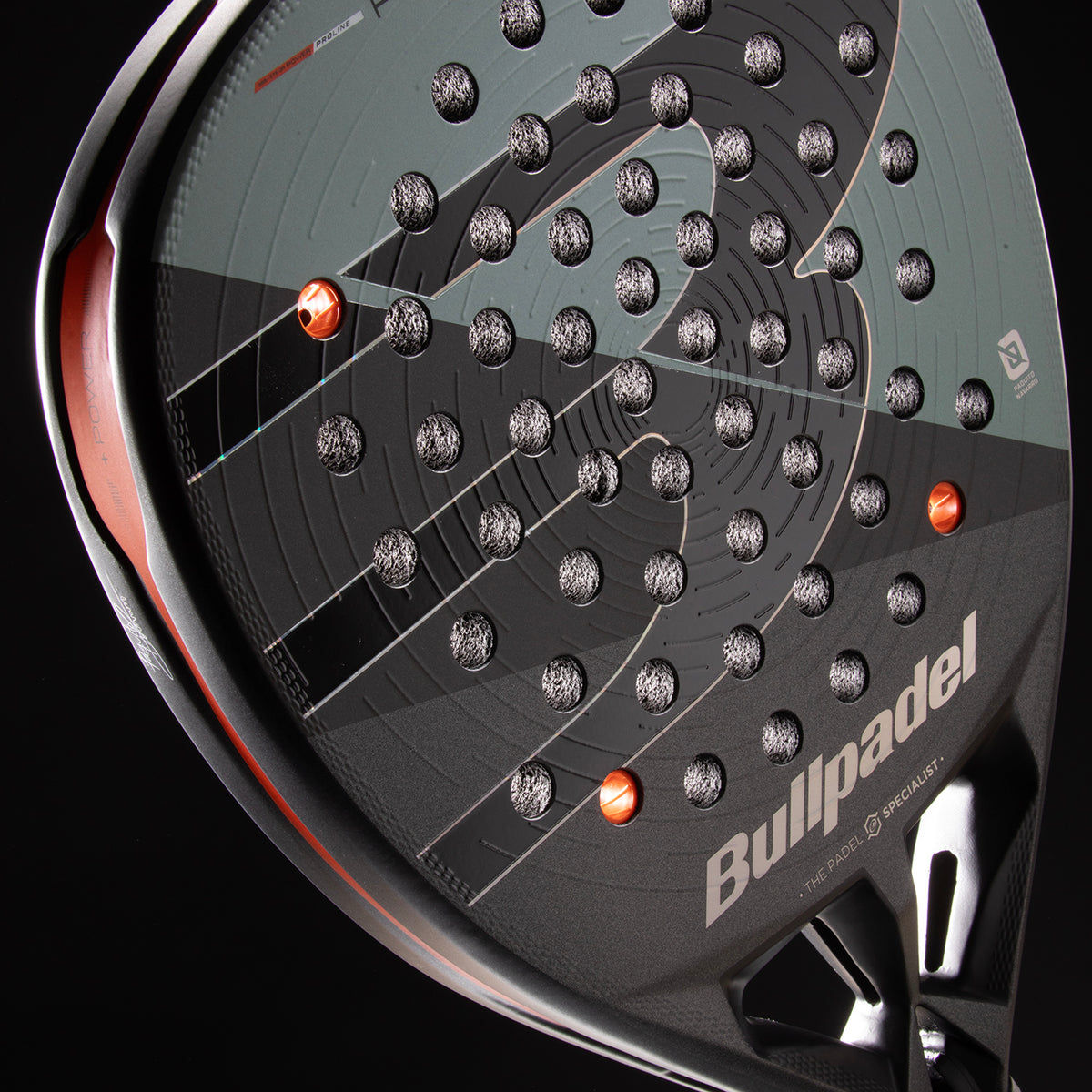 Angled close-up of face surface and orange weight inserts on Bullpadel Hack 04 Comfort 26 racket